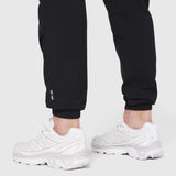 Black TETRA-LITE Training Jogger worn with white sneakers, cropped leg view