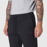 Black TETRA-LITE Training Jogger worn by model, front waist detail view