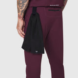 TETRA-LITE Training Jogger in merlot worn by model, side view with black towel