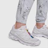 Model wearing white Tetra-Lite Training Jogger with white sneakers and colorful lace detail