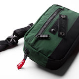 1231. Ripstop Crossbody Bag in forest green, worn with shoulder strap visible