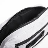 Flatlay 1231 Ripstop Crossbody Bag in white and black, open view showing interior
