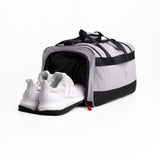 Flatlay 1234 Ripstop Duffle Bag in slate grey and black, open with white sneaker inside