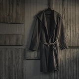 ASRV Heavyweight Robe in carbon, hung on hanger against wooden wall