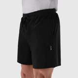 Aerotex™ 6" Training Short in black, worn by model with white shirt, side view