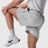Aerotex Training Short in Slate Grey worn by model stretching leg, front view