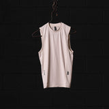 SM'22 Outlast® Base Layer Cutoff sleeveless tank in cream, displayed on hanger against dark background
