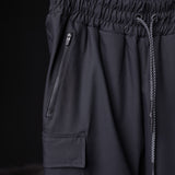 SP'20 Cargo Track Pant in black, detail shot of side pocket and drawstring