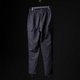 SP'20 Cargo Track Pant in charcoal gray, displayed on hanger against black background