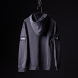 SP'20 Garment-Dyed Patch Hoodie in charcoal gray, displayed on hanger against black background
