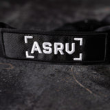 WN'19 Camera Strap closeup of black strap with ASRU logo and corner bracket details