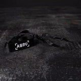 flatlay WN'19 Camera Strap in black, shot from above on dark textured surface