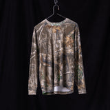 Flatlay of FA'23 Relaxed Long Sleeve in realtree camo, hung on black hanger against dark background