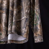 FA'23 Relaxed Long Sleeve in realtree camo, folded detail shot showing fabric and label