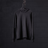 WN'22 Full Zip Training Hoodie in black, hung on hanger against dark brick wall