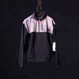 WN'23 Panel Quarter Zip Jacket in black and lavender, displayed on hanger against dark background