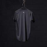 SM'22 Established Tee in charcoal gray, displayed on hanger against dark background, back view