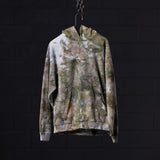FA'19 Reverse Weave Hoodie in multi-color floral tie-dye, hanging on chain against dark background