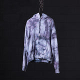 SM'22 Tie Dye Hoodie in lavender purple tie dye, displayed on hanger against dark background