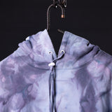 SM'22 Tie Dye Hoodie in purple tie dye, displayed on hanger showing drawstring detail