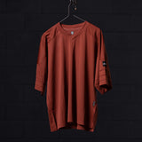 SM'23 Mesh Oversized Jersey in rust red, displayed on hanger front view