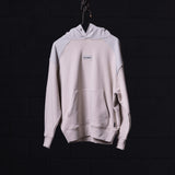 WN'23 Waterproof Panel Hoodie in light beige, displayed on hanger against dark background