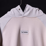WN'23 Waterproof Panel Hoodie in light purple, detail view of chest logo and hood