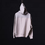 WN'23 Waterproof Panel Hoodie in light grey, displayed on hanger against dark background