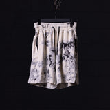 flatlay tie dye sweat shorts in cream and black, front view