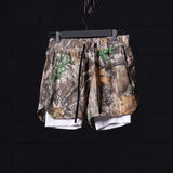 flatlay FA'23 5" Liner Short in realtree camo with white liner, hung on hanger
