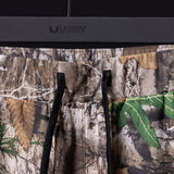 FA'23 5" Liner Short in green and tan leaf camo, hung on display with black straps