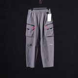 flatlay WN'23 Tetra™ City Pant in grey with cargo pockets, front view