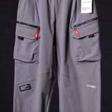 flatlay WN'23 Tetra™ City Pant in grey, front view with cargo pockets and red zippers