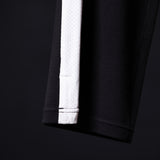 Flatlay of SM'24 Waffle Knit Sweat Pant in black with white cuff detail, laid flat on dark background