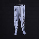 flatlay WN'22 Cargo High Rib Jogger in light gray with cargo pockets, front view