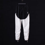 flatlay of 2021 Oversized Track Pant in black and white colorblock, front view