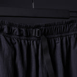 2021 Oversized Track Pant in black, detail shot of waistband and drawcord