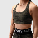 LYCRA® Hybrid Sports Bra in dark camo, modeled from front with waistband visible