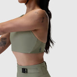 Sage LYCRA® Hybrid Sports Bra worn by model shown from side back view