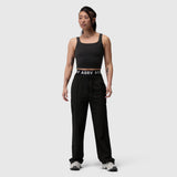 Black LYCRA® 2-in-1 tank top worn by model standing against neutral background