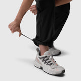 W036 Ripstop Relaxed Track Pant in black, worn with white sneakers, front view