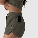 Tetra-Lite Linerless Short in olive worn by model, side view showing pockets
