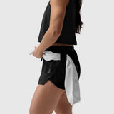 Tetra-Lite® Linerless Short in black, worn by model holding towel at waist, side view