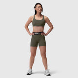 LYCRA® Hybrid Sports Bra in olive, worn by model standing facing forward with hands on hips
