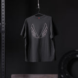 Black Tech Essential Relaxed Tee with white outline wing graphic, displayed on hanger