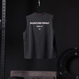 Black Tech Essential Relaxed Cutoff vest with 'Relentless Pursuit' text, hanging on hanger, back view