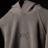 SS'20 Reverse Weave Hoodie in gray worn by model, front detail view showing ASRU logo