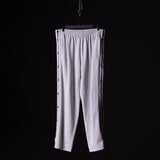 SP'22 Tearaway Jogger in light grey, displayed on hanger against black background