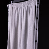 SP'22 Tearaway Jogger in gray, displayed on hanger against dark background