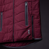 FA'22 Adventure Vest in burgundy, detail shot showing zipper pockets and quilted construction